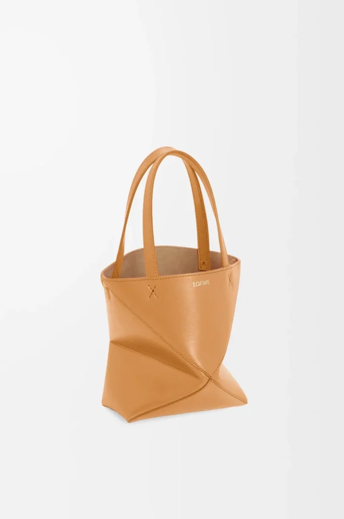 Bolso tote Puzzle Fold mini en piel de becerro brillante Warm Desert Bolso tote Puzzle Fold mini en piel de becerro brillante Warm Desert