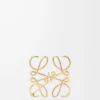 Broche Anagram en metal dorado Broche Anagram en metal dorado