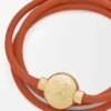 Pulsera Pebble de piel de becerro naranja/dorada
